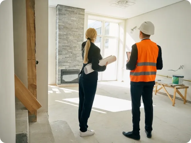 Landlord and contractor inspecting property renovation work
